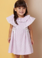 Model is wearing sweet Girls dress with ruffled collar sewn with the sewing pattern Butterick 7032