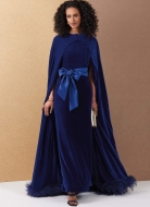 Model is wearing graceful Velvet dress with attached cape and tie belt sewn with the sewing pattern Vogue 2132