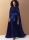 Model is wearing graceful Velvet dress with attached cape and tie belt sewn with the sewing pattern Vogue 2132