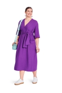 Model is wearing feminine Wrap-style midi dress sewn with the sewing pattern Burda 5724
